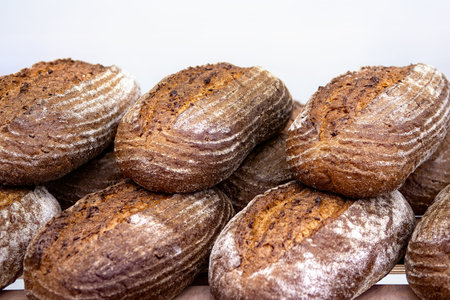 Loaves of dark rye bread on shelf. Sale of baked goods in the store.
