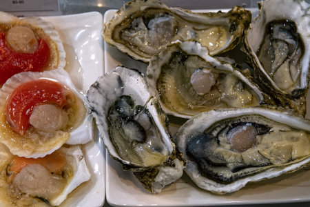 Fresh oysters and scallops in shells in seafood restaurant, top view.の写真素材