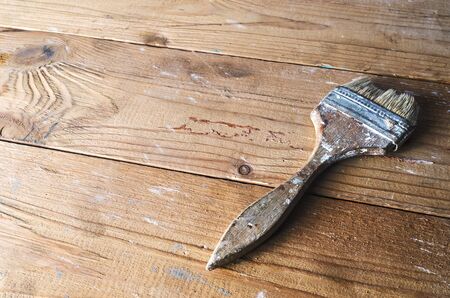 Old dirty vintage paint brush on grunge wooden background in vintage style with place for text, copyspaceの写真素材