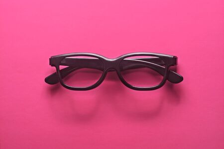 Flat lay fashion set: sunglasses on pastel backgrounds. Fashion summer is coming concept. Black glasses on a pink background, top view. Trendy colorful photo. Minimal style with colorful paper backdrop.の写真素材