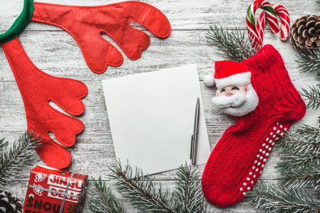 Template for Christmas card with fir tree border and copy space. Wooden table and natural pine...