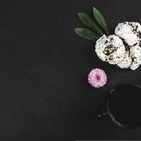 Cup of hot drink and cookies for break on stone black table. Top view with copy space for textの写真素材