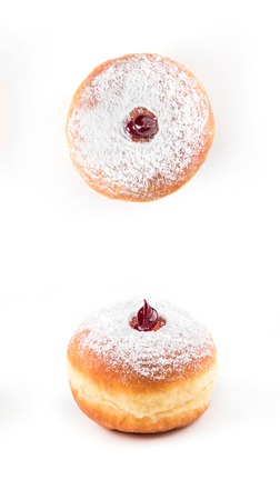 Closeup detail of tasty donut with powder and jam, isolated on white background. Top and side viewの写真素材