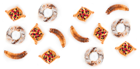 Top view of many delicious pastries isolated on white background. Flat lay, horizontal imageの写真素材