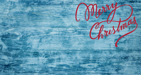 Christmas greeting card on old azure wood background. Top view. Space for textの写真素材