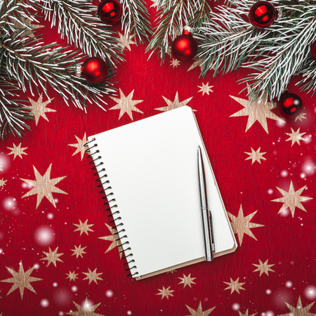 Xmas greeting card, notebook, for Santa's letter. Fir branches with Christmas balls. Top view. Snow effectの写真素材