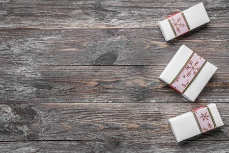 Christmas card with gifts on a dark wooden rustic background, place for text. Xmas and happy new year greeting card. Top view, flat lay.の写真素材