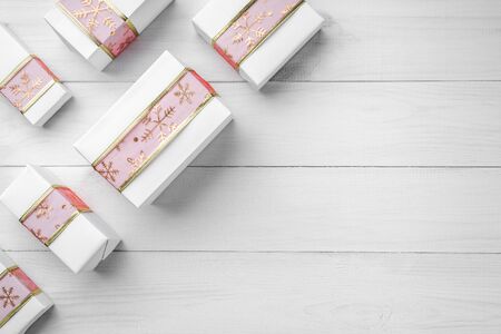 Christmas card with presents on white wooden background, space for text. Xmas and happy new year card. Top view, flat layの写真素材