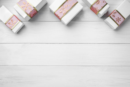 Christmas card with presents on white wooden background, space for text. Xmas and happy new year card. Top view, flat layの写真素材