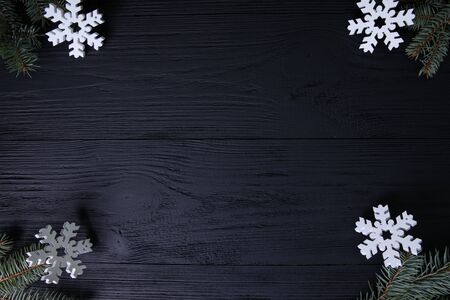 Winter holidays. Fir branches with gifts and flakesの写真素材