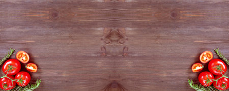 Rosemary and tomatoes on wooden background. Creative layout made of fresh vegetables. Flat lay, top viewの写真素材