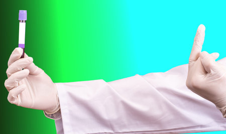 The hand in white disposable glove shows middle finger to a tube with infected blood of Coronavirus...