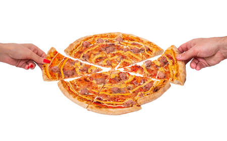 A hand of a man and a woman take slices of pizza, angle view. Tasty pizza with beef sausages, mozzarella, various sauces and marinated red onions, isolated on white backgroundの写真素材