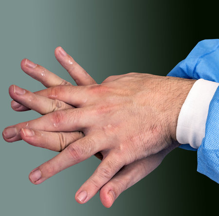 Doctor using antibacterial sanitizer on hands. Cleaning and disinfecting hands in proper way....