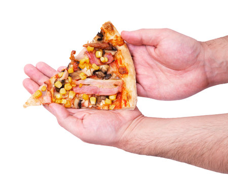 Delicious pizza slice with chicken breast, corn, bacon and mushrooms, in man's hands, isolated on...