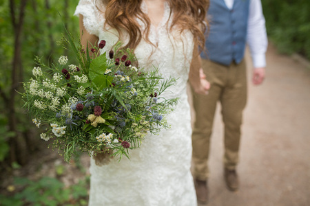 Beautiful wedding bouquet in the hands of the brideの写真素材