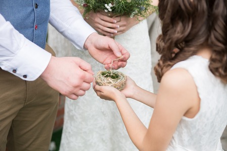 Little girl presents wedding gold rings newlywedsの写真素材
