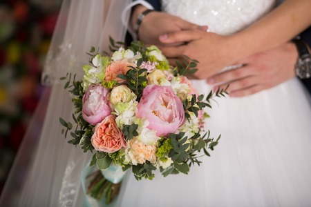 Beautiful wedding bouquet in the hands of the brideの写真素材