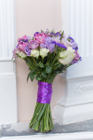 Beautiful wedding bouquet in the hands of the brideの写真素材