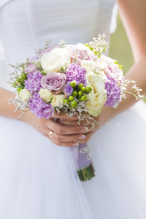 Beautiful wedding bouquet in the hands of the brideの写真素材