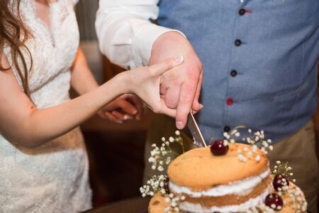 white multi level wedding cake with pink flower decorationsの写真素材