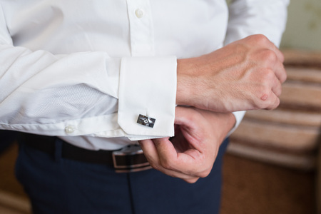 close up of a hand man how wears white shirt and cufflinkの写真素材