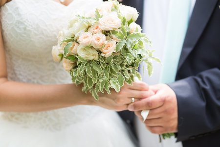 Beautiful wedding bouquet in hands of the bride