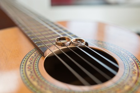 wedding gold rings on guitar. wedding conceptの写真素材