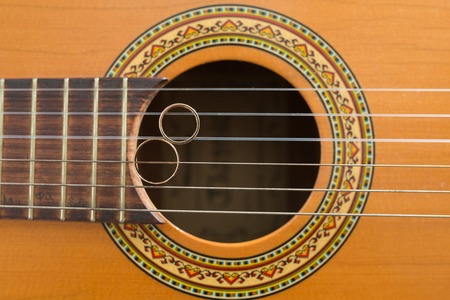 wedding gold rings on guitar. wedding conceptの写真素材