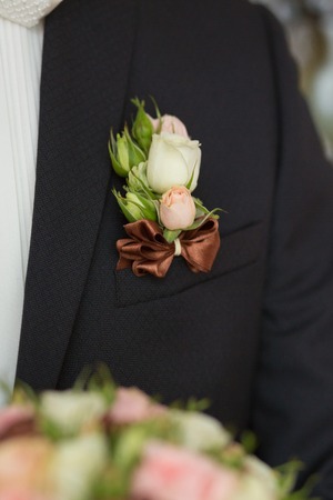 Boutonniere on hip trendy groom at weddingの写真素材