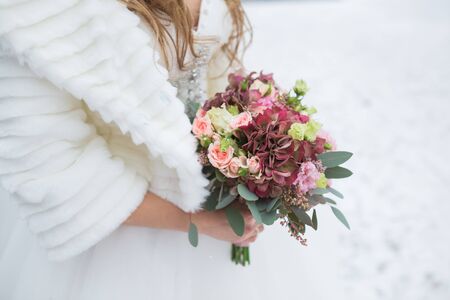 Beautiful wedding bouquet in hands of the brideの写真素材