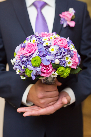 groom hold wedding bouquet in his handの写真素材