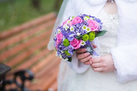 Beautiful wedding bouquet in hands of the brideの写真素材