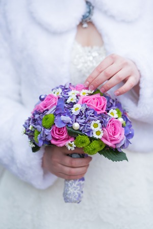 Beautiful wedding bouquet in hands of the brideの写真素材