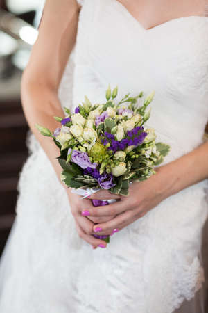 Beautiful wedding bouquet in hands of the brideの写真素材