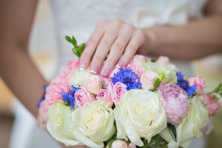 Beautiful wedding bouquet in hands of the brideの写真素材