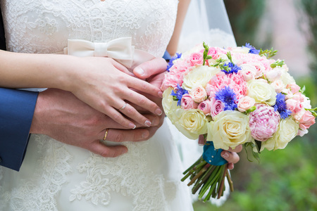 Beautiful wedding bouquet in hands of the brideの写真素材