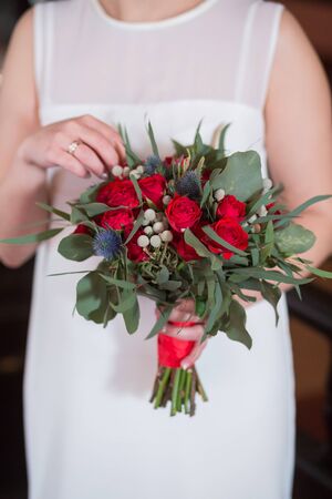 Beautiful wedding bouquet in hands of the brideの写真素材