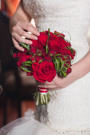 Beautiful wedding bouquet in hands of the brideの写真素材