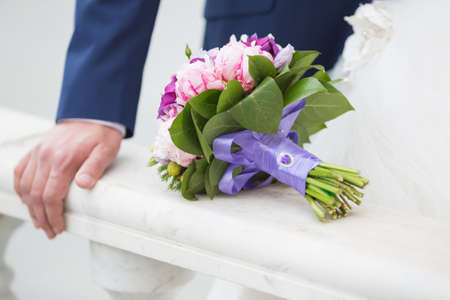 Beautiful wedding bouquet in hands of the brideの写真素材