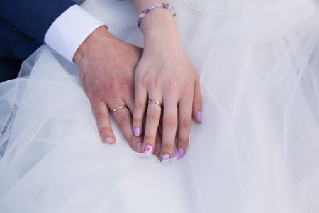 Bride and groom holding there hands outdoorsの写真素材