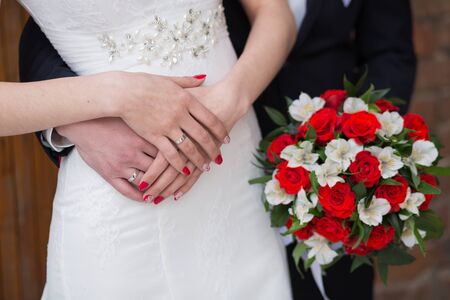 Beautiful wedding bouquet in hands of the brideの写真素材