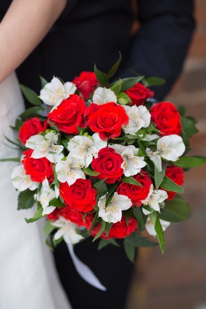 Beautiful wedding bouquet in hands of the brideの写真素材