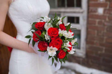 Beautiful wedding bouquet in hands of the brideの写真素材