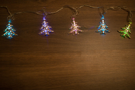 Christmas warm gold garland lights on wooden rustic backgroundの写真素材