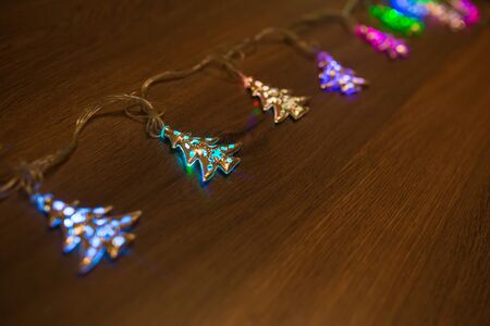 Christmas warm gold garland lights on wooden rustic backgroundの写真素材