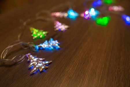 Christmas warm gold garland lights on wooden rustic backgroundの写真素材