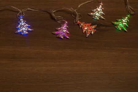 Christmas warm gold garland lights on wooden rustic backgroundの写真素材