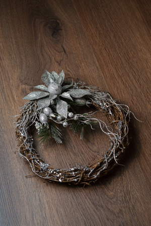 Christmas silver wreath on the wooden backgroundの写真素材