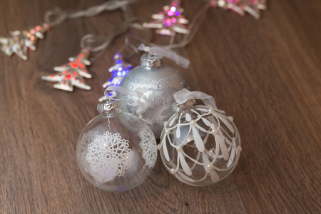 wooden table with defocused christmas  lights and glass ballsの写真素材